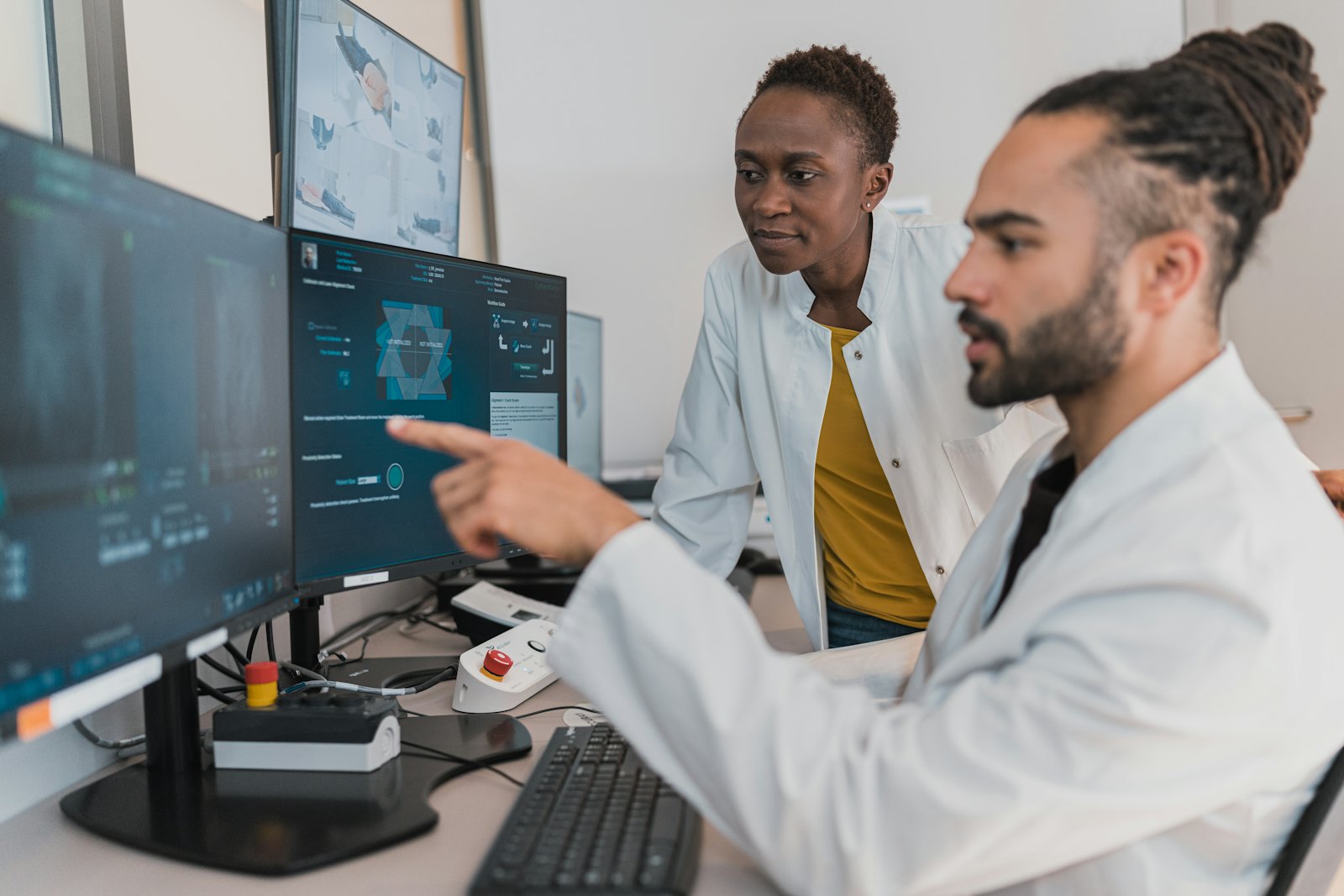 Two clinicians discussing information on a screen.